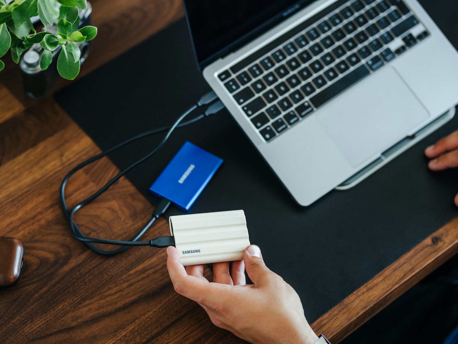 a person holding a card next to a laptop